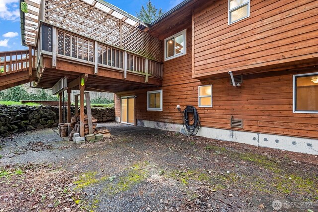 view of side of property featuring crawl space and a deck