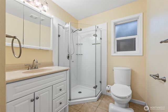 full bath with toilet, a stall shower, tile patterned flooring, baseboards, and vanity