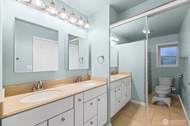 full bath with tile patterned flooring, double vanity, and a sink