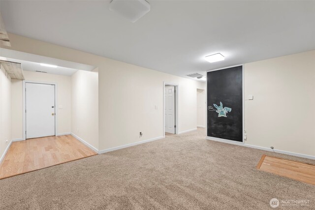 below grade area featuring visible vents, baseboards, and carpet