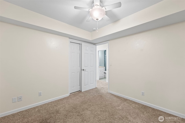 spare room with baseboards, ceiling fan, and carpet flooring