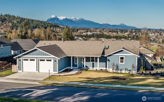 30 Sundae Dr, Sequim, WA 98382 - ranch-style house featuring a mountain view, a front lawn, driveway, and board and batten siding
