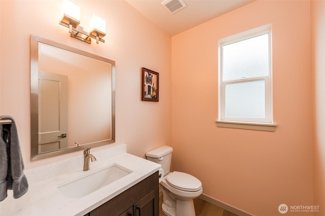 30 Sundae Dr, Sequim, WA 98382 - bathroom featuring vanity, toilet, wood finished floors, and visible vents