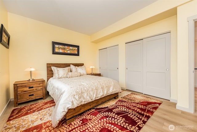 30 Sundae Dr, Sequim, WA 98382 - bedroom with baseboards, two closets, and light wood-style floors