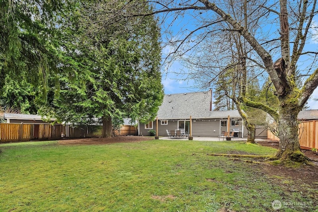 view of yard with a patio area and a fenced backyard