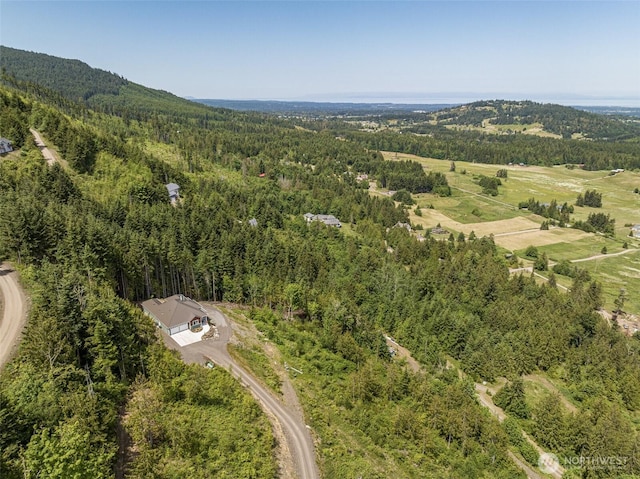 aerial view featuring a wooded view