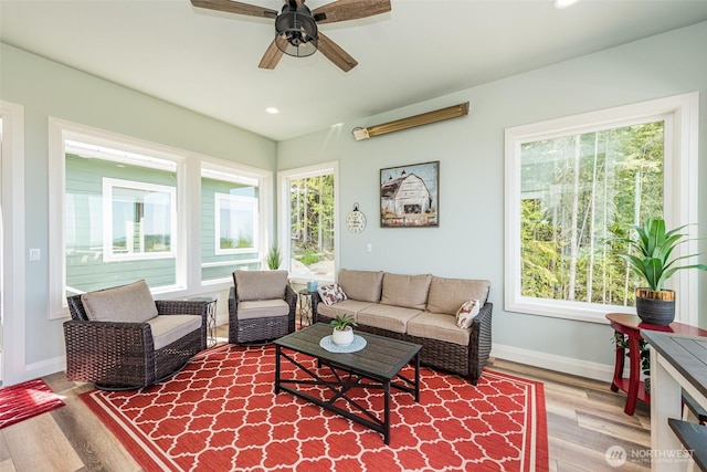 living area featuring recessed lighting, a healthy amount of sunlight, baseboards, and wood finished floors