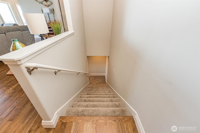 stairs with baseboards and wood finished floors