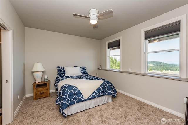 carpeted bedroom featuring a ceiling fan and baseboards