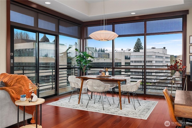 dining room featuring expansive windows, plenty of natural light, and wood finished floors