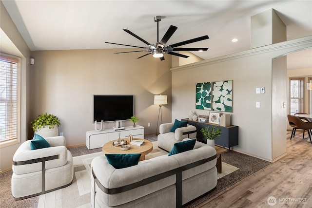 living room with baseboards, lofted ceiling, plenty of natural light, and wood finished floors