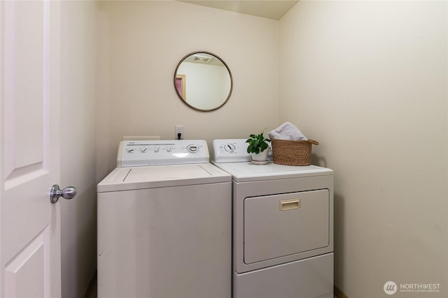 clothes washing area with laundry area and washer and dryer