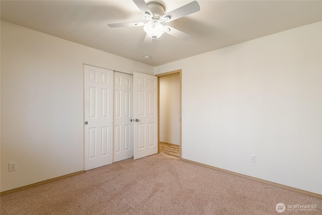 unfurnished bedroom with light colored carpet, baseboards, a closet, and ceiling fan