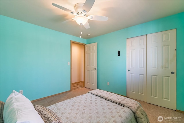 bedroom with a closet, baseboards, light carpet, and ceiling fan