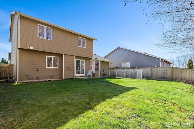 rear view of house featuring crawl space, a yard, and a fenced backyard