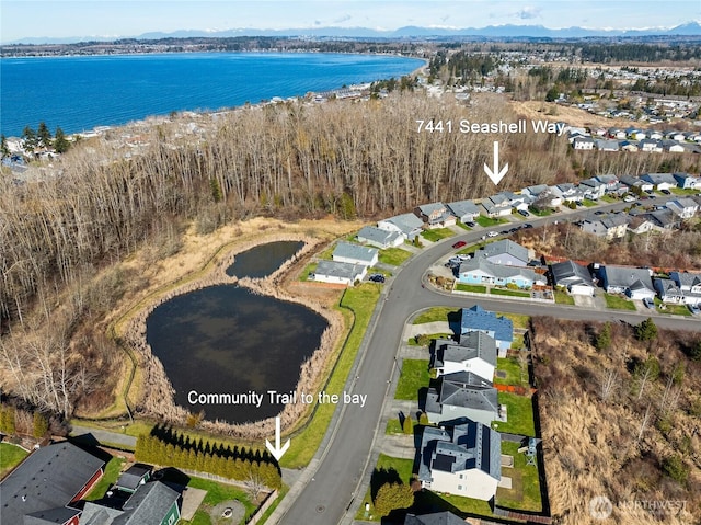 birds eye view of property with a residential view and a water view