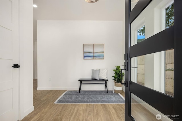 foyer featuring wood finished floors and baseboards