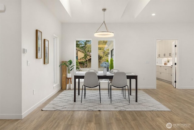 dining room with recessed lighting, baseboards, and light wood-style floors