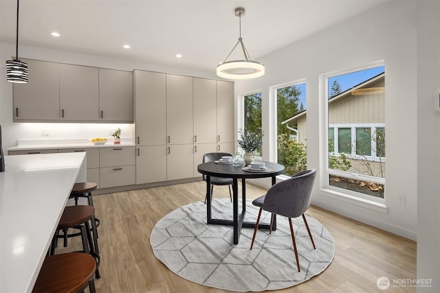 dining space with recessed lighting and light wood-style flooring