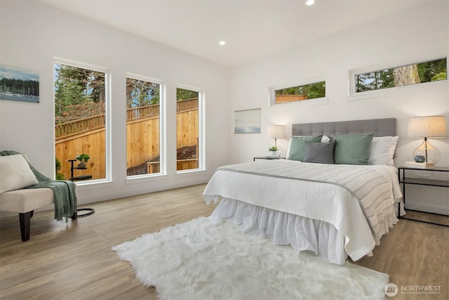 bedroom featuring recessed lighting and wood finished floors