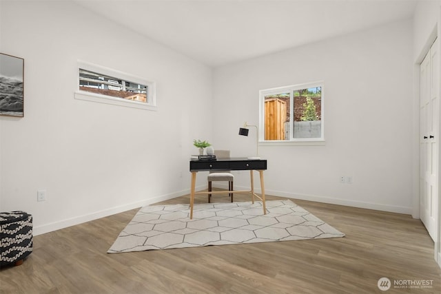 office area with baseboards and wood finished floors