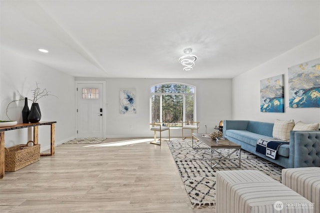 living area with light wood finished floors and baseboards