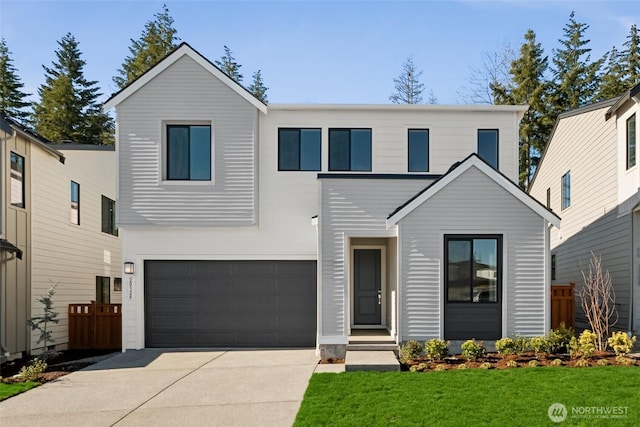 view of front of house featuring a garage, a front yard, driveway, and fence