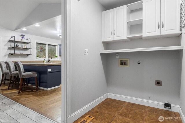 laundry area featuring hookup for a washing machine, visible vents, cabinet space, electric dryer hookup, and hookup for a gas dryer