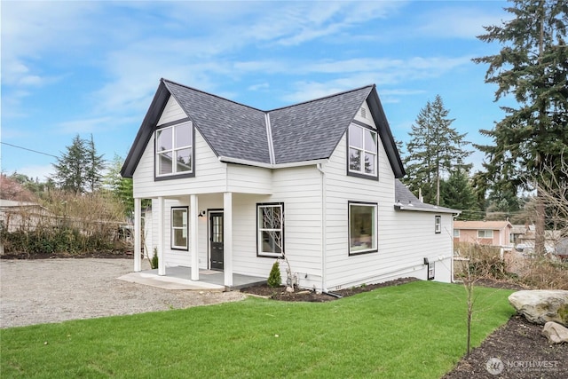 exterior space featuring a front yard, a porch, and a shingled roof