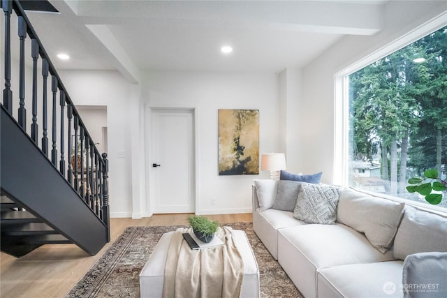 living area with baseboards, stairway, beamed ceiling, recessed lighting, and light wood-style floors