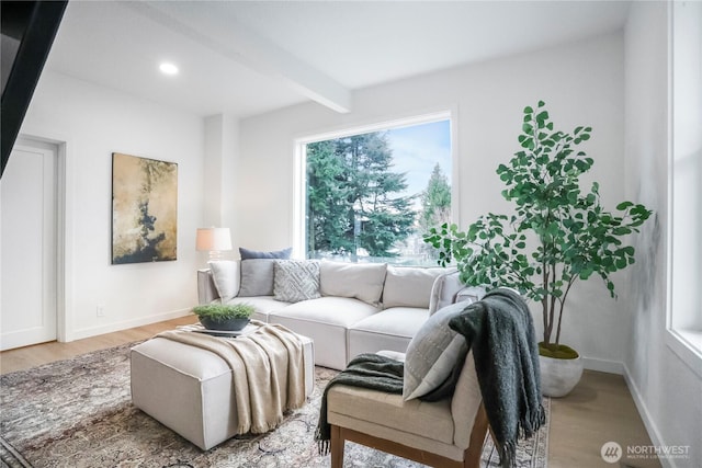 living room featuring beamed ceiling, recessed lighting, baseboards, and wood finished floors