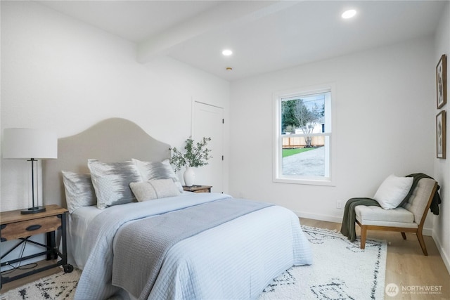 bedroom featuring recessed lighting, beamed ceiling, baseboards, and light wood-style floors