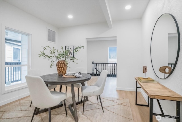 dining space with beamed ceiling, recessed lighting, baseboards, and light wood finished floors