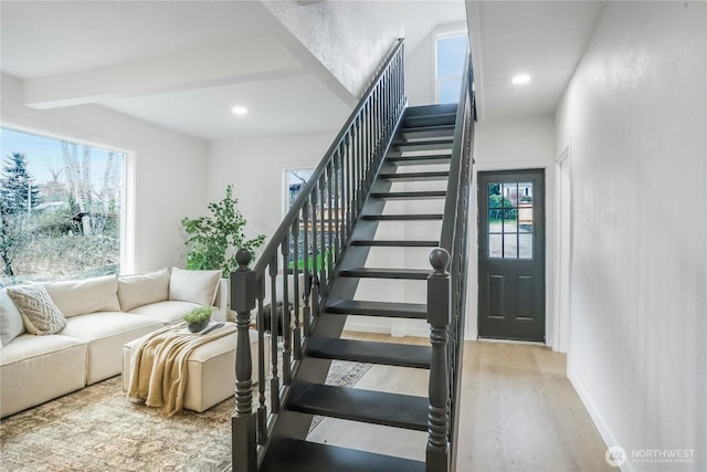 stairway featuring beamed ceiling, recessed lighting, wood finished floors, and baseboards