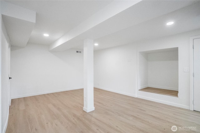 finished basement with recessed lighting, visible vents, baseboards, and light wood-style flooring