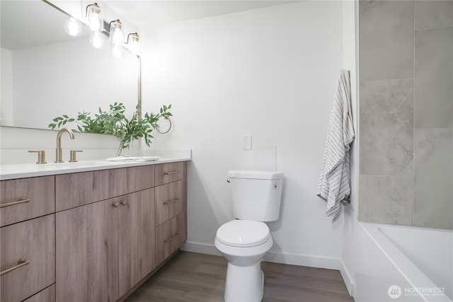 full bath with vanity, toilet, wood finished floors, and baseboards