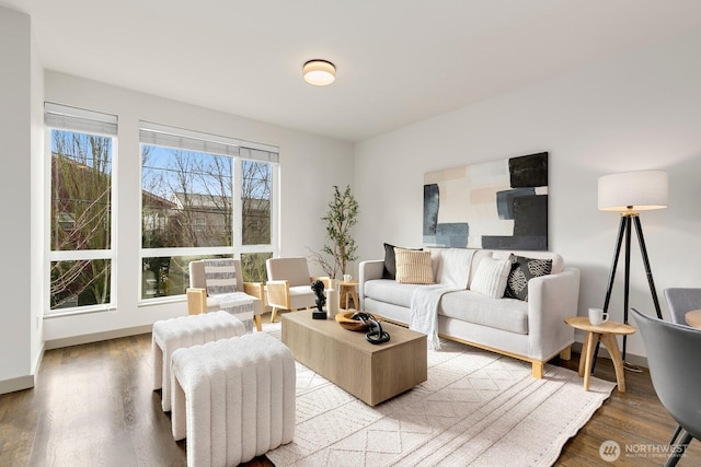 living area with light wood-style flooring and baseboards