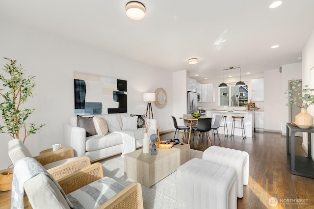 living area with dark wood finished floors, recessed lighting, and baseboards