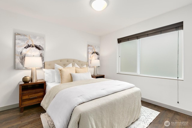 bedroom with baseboards and wood finished floors