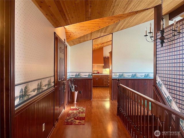 hall with wainscoting, wooden ceiling, and wallpapered walls