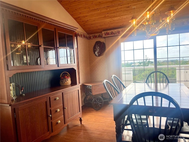 dining area with wooden ceiling, wood finished floors, and vaulted ceiling