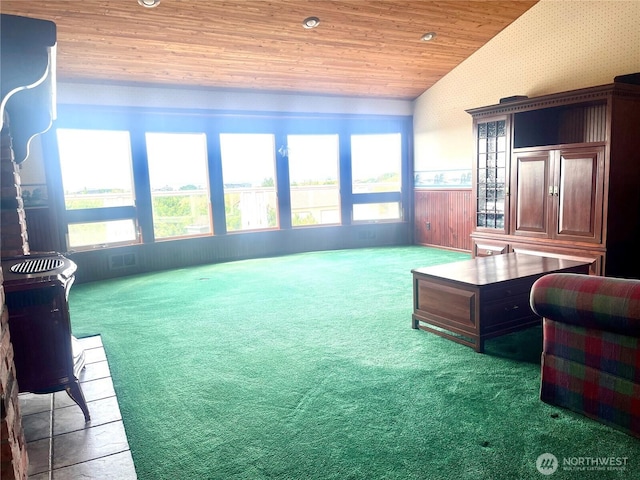 carpeted living area featuring wallpapered walls, lofted ceiling, recessed lighting, wainscoting, and wooden ceiling