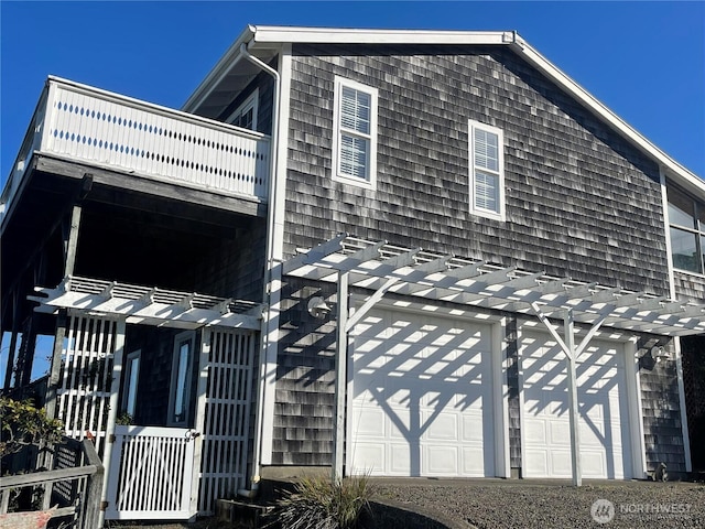 view of side of property with a balcony and a garage