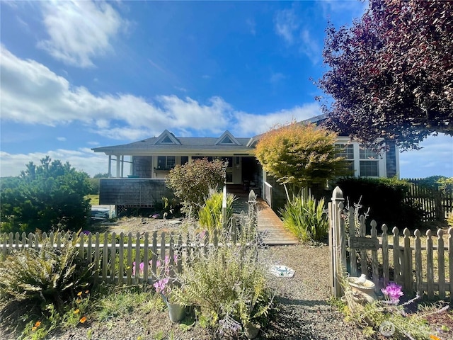 view of front of home featuring fence