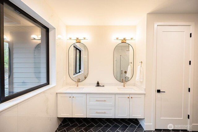 bathroom featuring a sink and double vanity