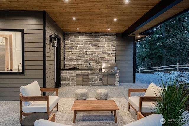 view of patio featuring an outdoor kitchen and fence