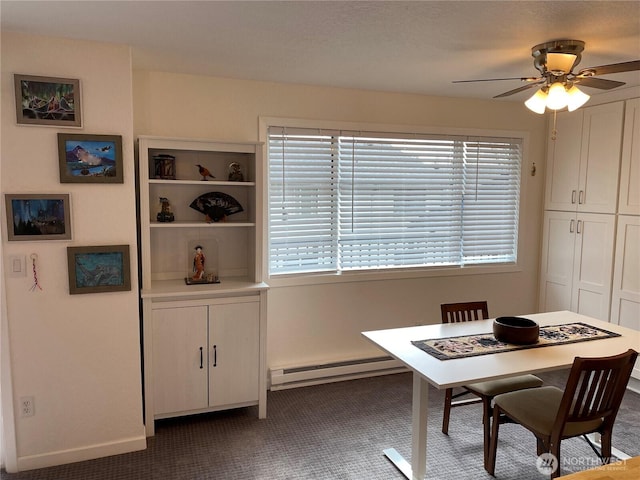 carpeted dining space with a baseboard heating unit, baseboards, and ceiling fan