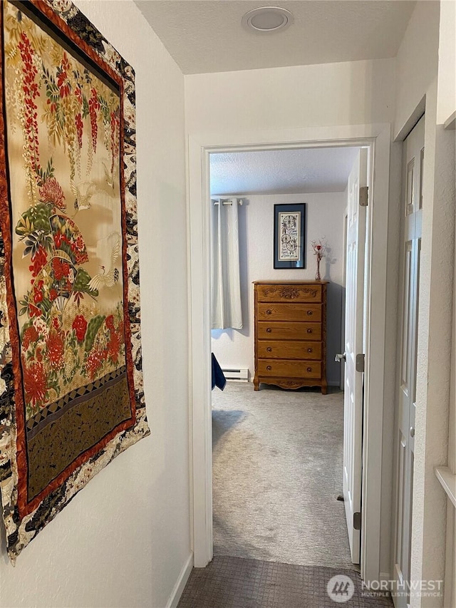 corridor featuring a baseboard radiator and carpet floors