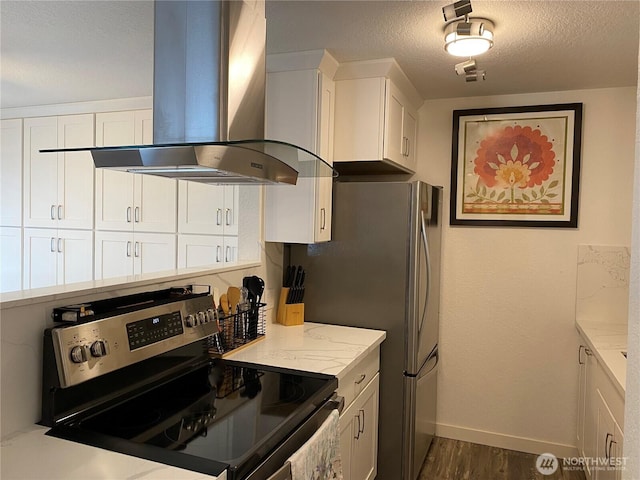 kitchen with light stone counters, stainless steel electric stove, white cabinets, a textured ceiling, and wall chimney range hood