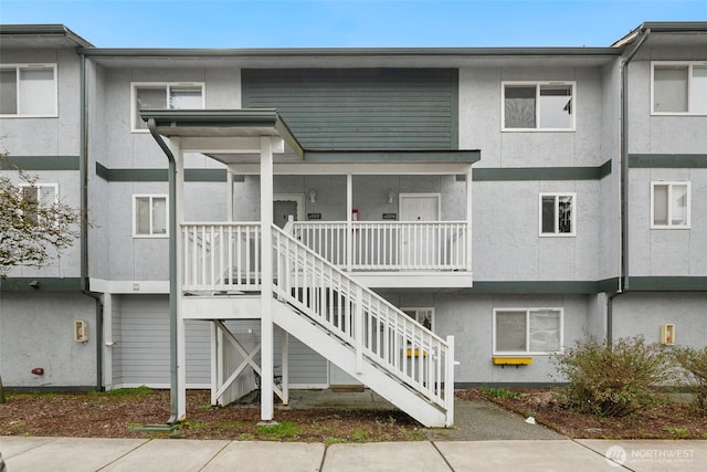 exterior space featuring stairs and stucco siding